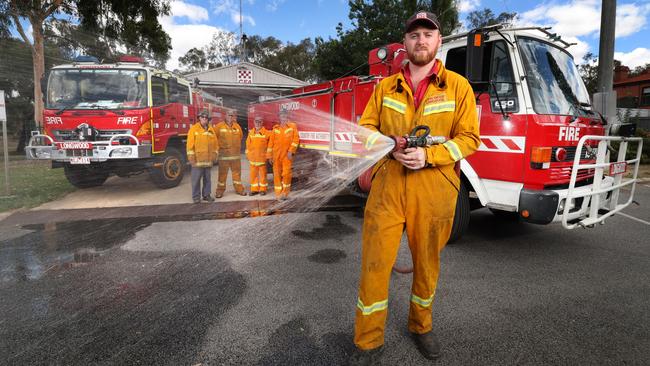 John Brodie Jnr stands in front of fire trucks that are 28-years-old and 13-years-old. Picture: David Caird