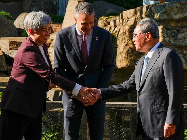 ADELAIDE, AUSTRALIA - JUNE 16: Australia's Foreign Minister Penny Wong (L) shakes hands with China's Premier Li Qiang at as South Australian Premier Peter Malinauskas (C) looks on Adelaide Zoo on June 16, 2024 in Adelaide, Australia. Li's visit to Australia aims to strengthen bilateral ties and address outstanding trade and consular issues, including the removal of remaining trade barriers and the release of imprisoned Australian democracy blogger Yang Hengjuno, marking a significant step towards stabilizing the relationship between the two nations. The visit also highlights the growing importance of economic cooperation and the need for dialogue on security concerns, particularly in the context of China's increasing influence in the Pacific region. The visit marks the first high-level diplomatic by a Chinese leader to Australia since 2017. (Photo by Asanka Ratnayake/Getty Images)