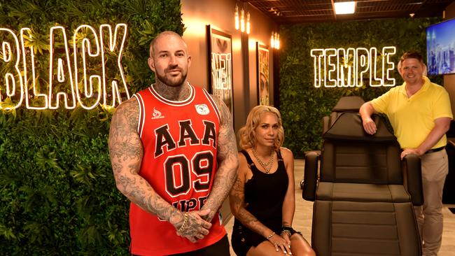 Chris Bowtell at Black Temple Tattoo in Flinders Street with piercer Lutana Gawthorne and Ray White Commercial director Troy Townsend. Picture: Evan Morgan