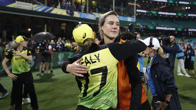 Injured superstar Ellyse Perry hugs wicketkeeper Alyssa Healy after Australia’s gripping World Cup T20 semi-final win overSouth Africa at the SCG. Picture: Getty Images