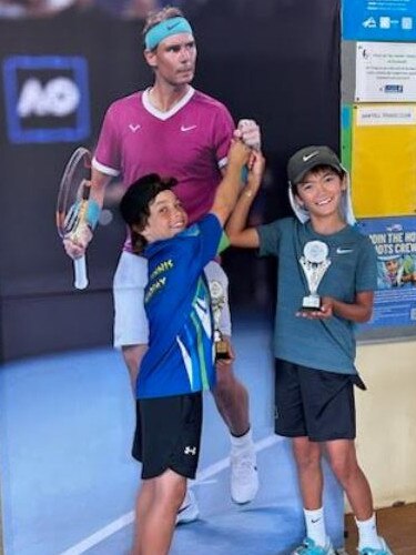 Joshua poses for a shot with a cardboard poster of Rafael Nadal.