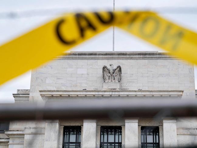 The US Federal Reserve building is seen past caution tape in Washington, DC, on September 19, 2022. - Stock markets wobbled following last week's rout as investors expect another big rate hike by the US Federal Reserve that they fear could drag down the global economy. (Photo by Stefani Reynolds / AFP)