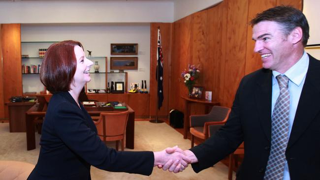 Julia Gillard greets Rob Oakeshott at her office in Canberra.