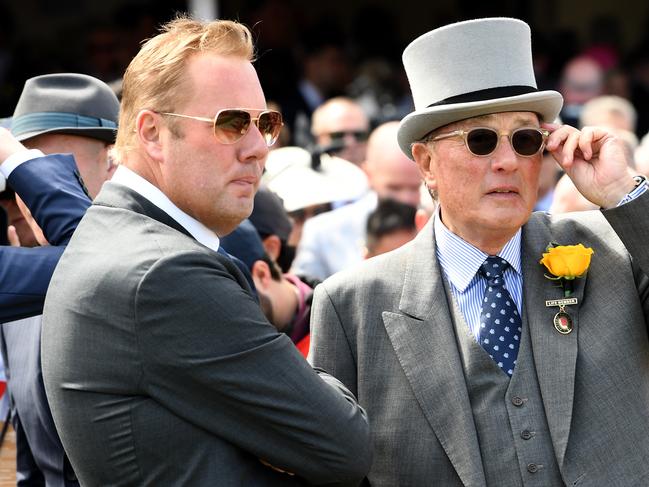 Lloyd Williams is seen with his son Nick (left) in the mounting yard after his horse Rekindling won the Melbourne Cup at Flemington Racecourse in Melbourne on Tuesday, November 7, 2017. (AAP Image/Joe Castro) NO ARCHIVING