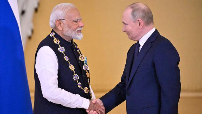 Russian President Vladimir Putin decorates Indian Prime Minister Narendra Modi with the Order of St. Andrew the Apostle the First-Called during a ceremony following their talks at the Kremlin in Moscow. Picture: AFP