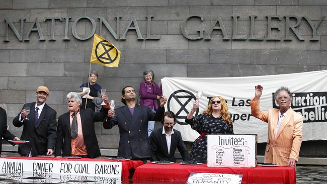 Extinction Rebellion protestors eat coal at a ‘Last Supper’ in the moat of the NGV. Picture: David Caird