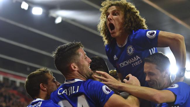 Chelsea's Brazilian defender David Luiz (2R) jumps in to celebrate.