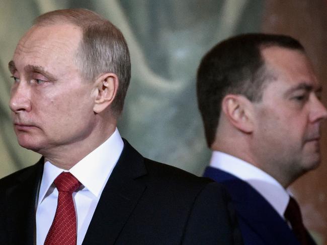 (FILES) In this file photo taken on April 08, 2018 Russian President Vladimir Putin (L) and Prime Minister Dmitry Medvedev attend an Orthodox Easter ceremony in Moscow. - Russia's government resigned in a shock announcement on January 15, 2020 after President Vladimir Putin proposed a series of constitutional reforms. In a televised meeting with the Russian president, Prime Minister Dmitry Medvedev said the proposals would make significant changes to the country's balance of power and so "the government in its current form has resigned". (Photo by Alexander NEMENOV / AFP)