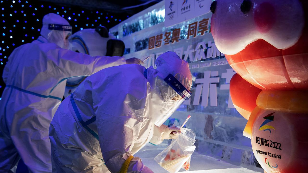 Health workers collect samples to be tested for Covid-19 at an ice and snow themed park. Picture: AFP