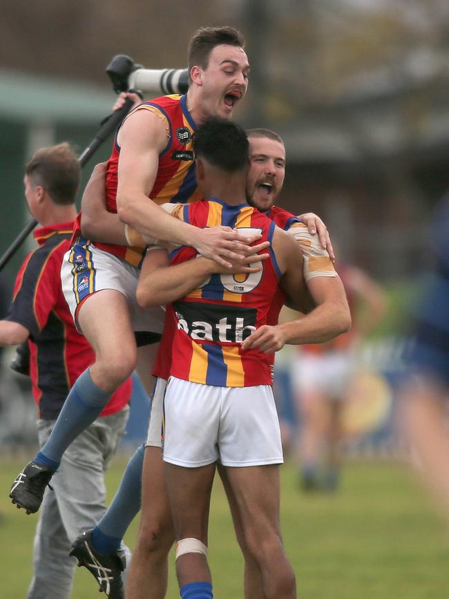 Winners Old Ignations are grinners at the final siren. Picture Dean Martin