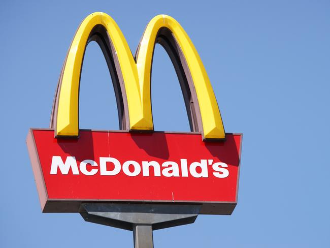 Ljubljana, Slovenia - September 3, 2011: Close-up of McDonalds outdoor sign with typical rounded yellow M letter against cloudless blue sky. Sign is positioned on the left side of image.