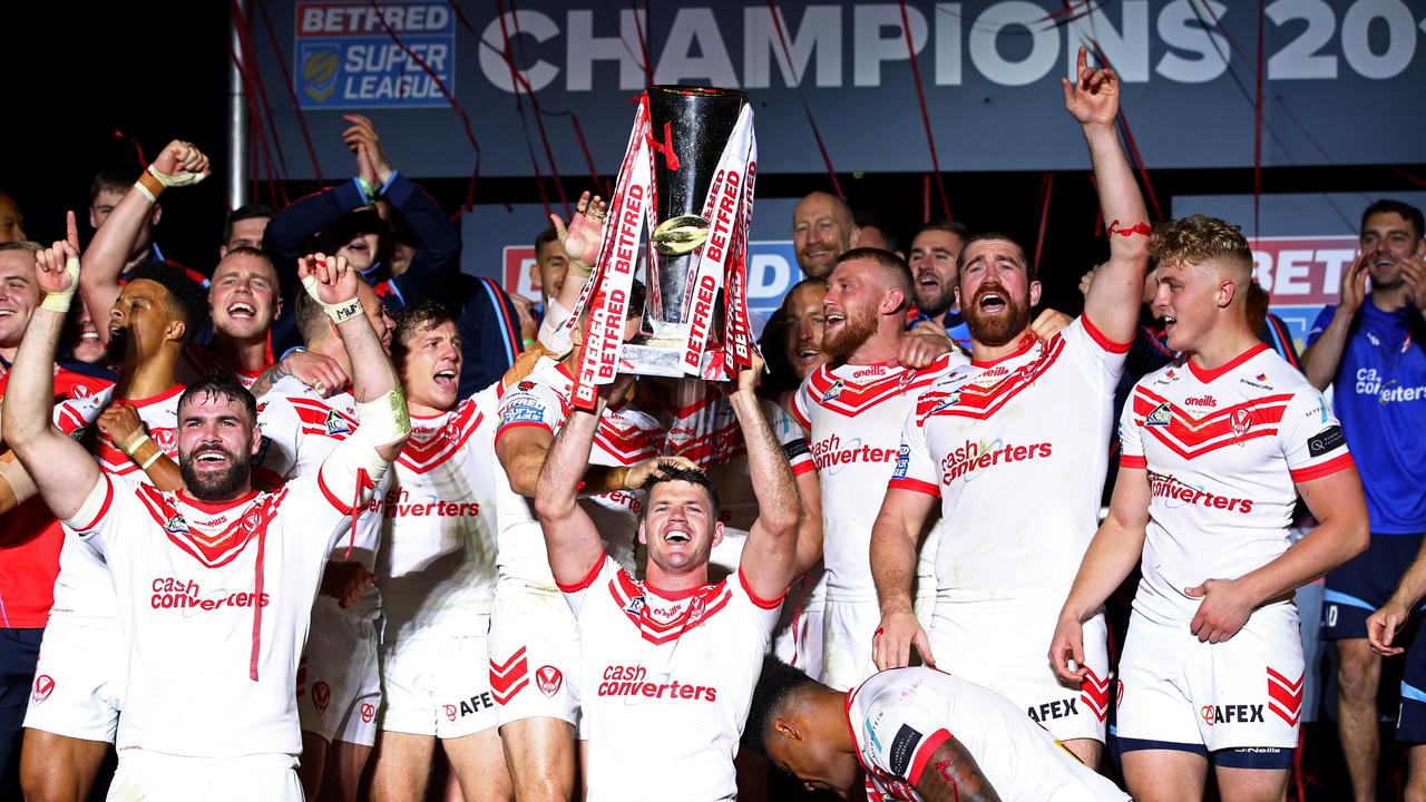 Lachlan Coote of St Helens lifts the trophy as he celebrates his team's victory after the Betfred Super League Grand Final.