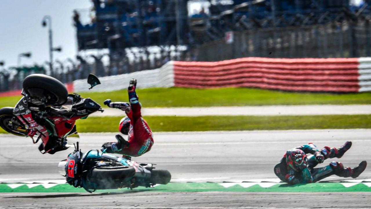 Andrea Dovizioso (L) about to hit the deck following the horror crash. Pic: MotoGP.com