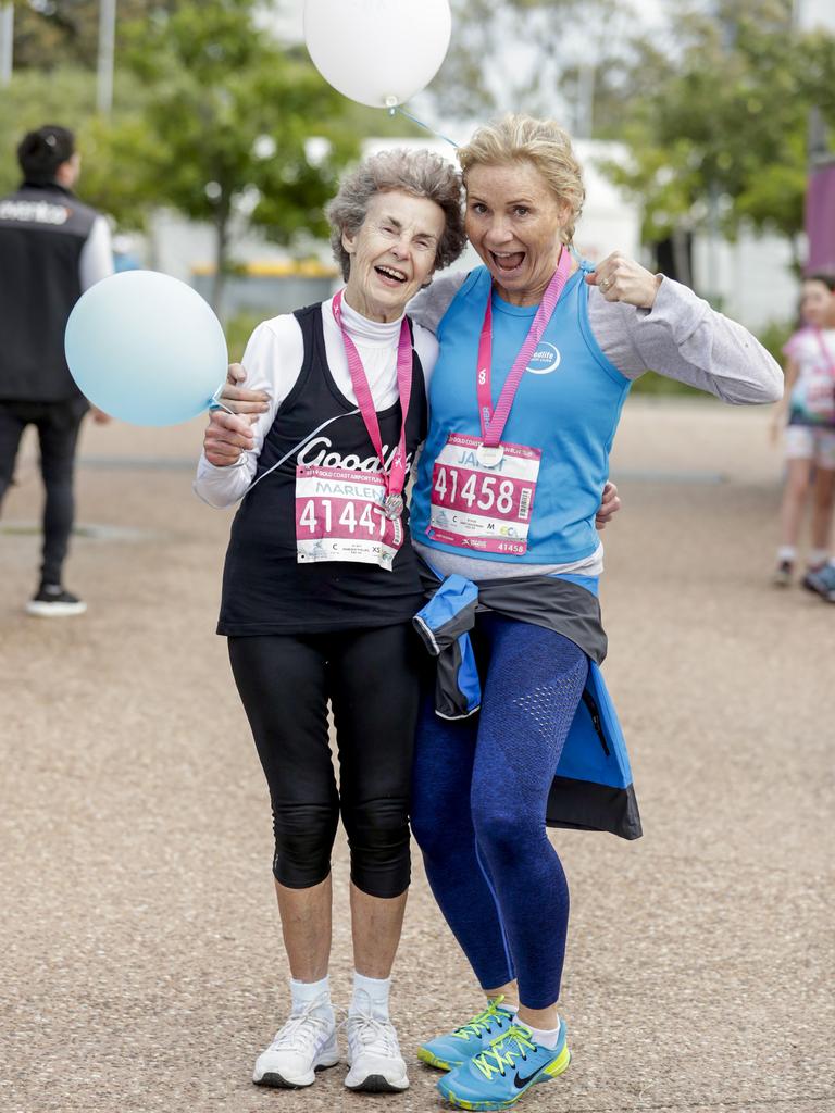 Marlene Phillips, from Ashmore who is turning 80 tomorrow celebrates with a friend at the finish the Gold Coast Airport Fun Run. Picture: Tim Marsden.