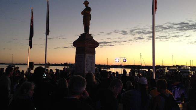 Crowds watch as the sun rises at the conclusion of the Southport dawn service. Photo: Richard Gosling