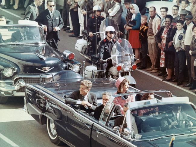 President and Mrs. John F. Kennedy smile at the crowds just prior to the assassination.