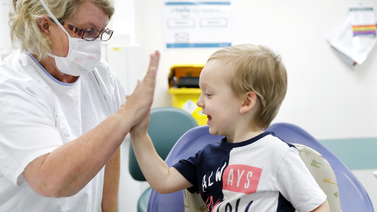 Oral health therapist Julie Johnson high fives Alexander after a checkup. Picture: AAP