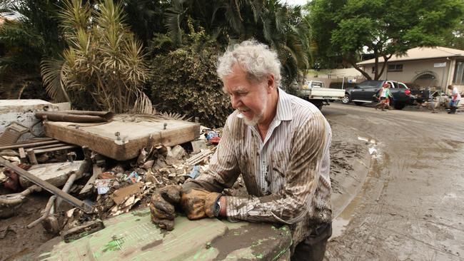 Residents of Donatello St in Fig Tree Pocket cleaned up after the flood. Volunteer Peter Blundesen stopped to catch his breath.