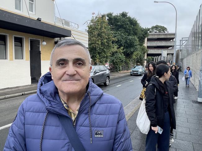 Joe Occhiuto waits in a long queue at Lidcombe train station amid commuter chaos on Wednesday.