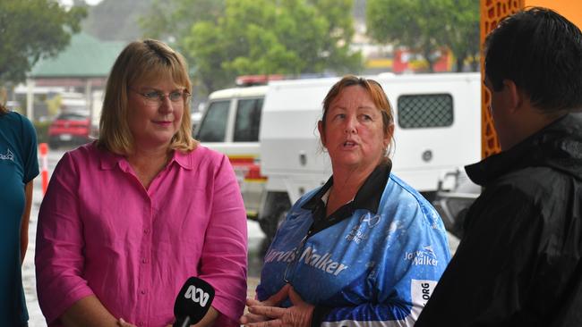 Hinchinbrook Shire Council Deputy Mayor Mary Brown (right), flanked by Minister for Local Government and Water and Minister for Fire, Disaster Recovery and Volunteers Ann Leahy, speaking outside the council headquarters in flood-ravaged Ingham on Tuesday. Picture: Cameron Bates