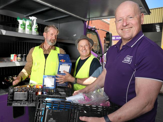 More South Australians than ever, are going hungry because of rising cost of living. At Foodbank headquarters at Edwardstown, volunteers, Chris Rankin (beard) and Alan Biss, with CEO Greg Pattinson, (F), loading a van with food for delivery. 20 October 2023. Picture Dean Martin