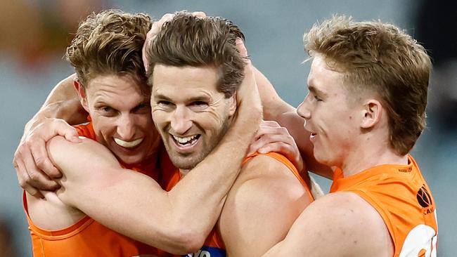 MELBOURNE, AUSTRALIA - JULY 14: (L-R) Lachie Whitfield, Callan Ward and Harvey Thomas of the Giants celebrate during the 2024 AFL Round 18 match between the Richmond Tigers and the GWS GIANTS at Melbourne Cricket Ground on July 14, 2024 in Melbourne, Australia. (Photo by Michael Willson/AFL Photos via Getty Images)