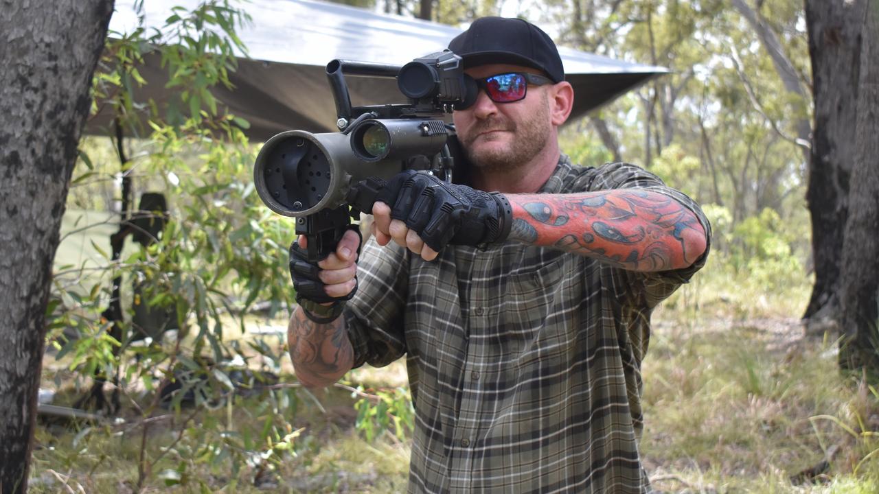 OPERATION TEMPEST: David Peters from Brisbane poses with a prop rocket launcher during Operation Tempest on the Fraser Coast. Photo: Stuart Fast