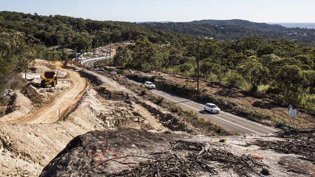 Heavy machinery will flatten out the terrain to allow the widening of Mona Vale Rd East to four lanes. Picture: RMS