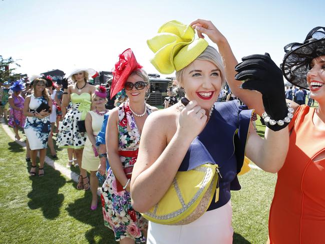 Melbourne Cup Day 2014 Myer Fashion in the Field at Flemington Racecourse. Lining up for Myer Fashions in the Field, hopeful Melanie Plane puts on a last minute touch up with the help of friend Katie Halstead.           Picture: David Caird.