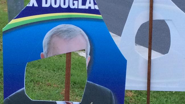 Election signs in Gaven continue to be defaced in the lead-up to Saturday's poll. Sitting member Alex Douglas's face has been cut out of these signs at Nerang.