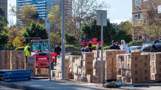 Residents receive a resupply of goods during the public housing lockdown. Picture: Jake Nowakowski