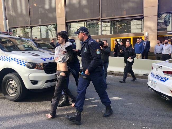 Mert Ney being detained by police in Sydney. Picture: AAP