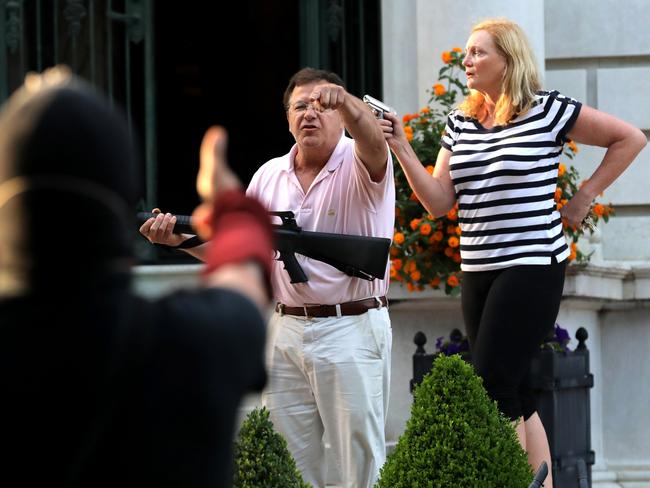 The couple, brandishing guns, got into a verbal stoush with protesters. Picture: AP