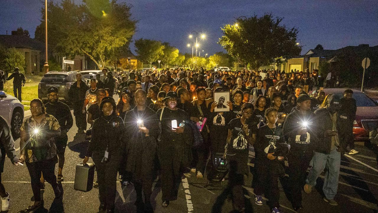 Mourners hold a candlelight vigil for slain 23-year-old Nathan Mwanza after he was violently killed in Wyndham Vale. Picture: Jake Nowakowski