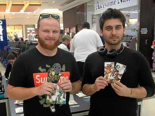 Michael Cunningham and Lochlan Charmers at the Royal Australian Mint's pop up shop in Stockland. Picture: Jann Houley