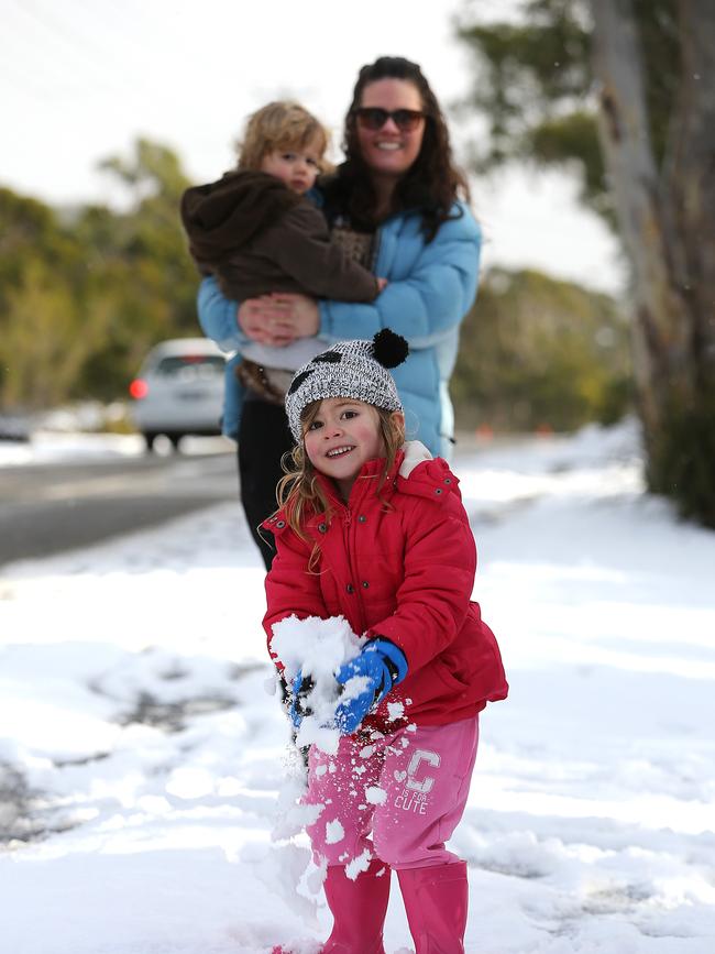 Ivy Salmon 3 1/2 of Mount Nelson playing in the snow on Olinda Grove watched by mum Celia and brother Oscar 1
