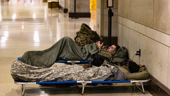 National Guard soldiers rest on cots in the visitors centre of the US Capitol. Picture: Getty Images