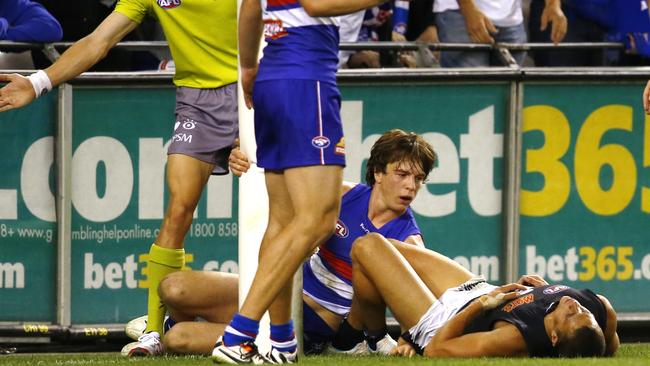 Ed Curnow cleans up the point post when tackled by Liam Picken in a 2014 match. Pic: Michael Klein.