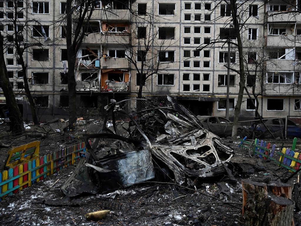 A destroyed car next to a damaged residential building following a missile strike in Kyiv, amid the Russian invasion of Ukraine. Picture: AFP