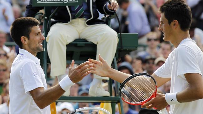 Bernard Tomic shakes hands with Novak Djokovic after their 2011 Wimbleon quarter-final.