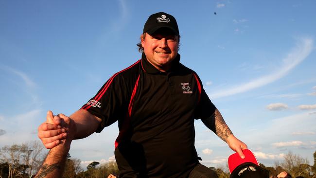 Dean Helmers coach of Romsey walks on to the stage to collect the premiership cup. Picture: Mark Dadswell