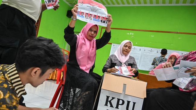 Election staffers count ballots at a polling station in Banda Aceh after Indonesians voted to pick local leaders in the country's biggest simultaneous regional election. Picture: CHAIDEER MAHYUDDIN/AFP