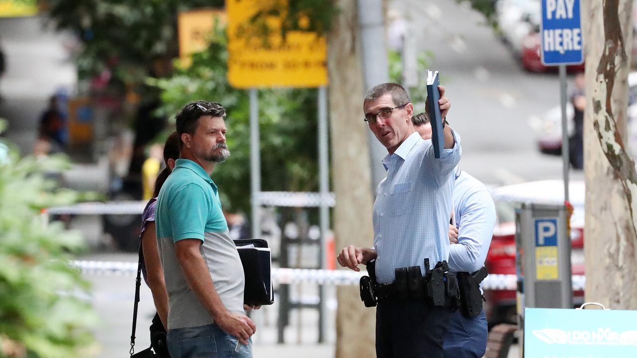 Detectives at the police shooting on Mary Street in front of the Westin hotel, Brisbane. Photographer: Liam Kidston.