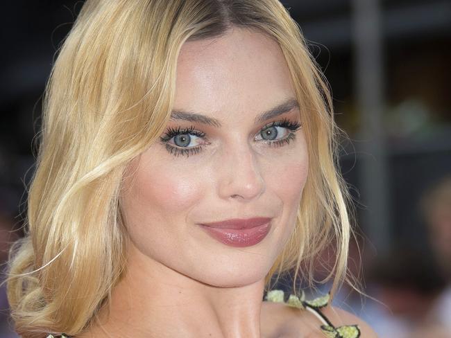 FILE - In this Aug. 3, 2016 file photo, actress Margot Robbie poses for photographers upon arrival at the European Premiere of 