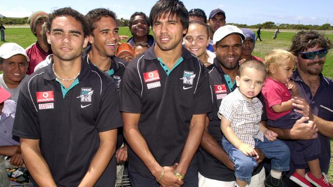 Shaun Burgoyne, Peter Burgoyne, Che Cockatoo Collins and Byron Pickett with supporters during a Power visit to Mallee Park Football Club, Port Lincoln in 2003.