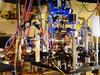 This photo released August 22, 2013, courtesy of the National Institute of Standards and Technology shows NIST's ultra-stable ytterbium lattice atomic clock. Ytterbium atoms are generated in an oven (large metal cylinder on the left) and sent to a vacuum chamber in the center of the photo to be manipulated and probed by lasers. Laser light is transported to the clock by five fibers (such as the yellow fiber in the lower center of the photo). A pair of experimental atomic clocks based on ytterbium atoms at the National Institute of Standards and Technology (NIST) has set a new record for stability. The clocks act like 21st-century pendulums or metronomes that could swing back and forth with perfect timing for a period comparable to the age of the universe.  NIST physicists report in the August 22, 2013 issue of Science Express that the ytterbium clocks' tick is more stable than any other atomic clock. Stability can be thought of as how precisely the duration of each tick matches every other tick. AFP PHOTO / NIST == RESTRICTED TO EDITORIAL USE / MANDATORY CREDIT: "AFP PHOTO / NIST / NO MARKETING / NO ADVERTISING CAMPAIGNS / DISTRIBUTED AS A SERVICE TO CLIENTS ==