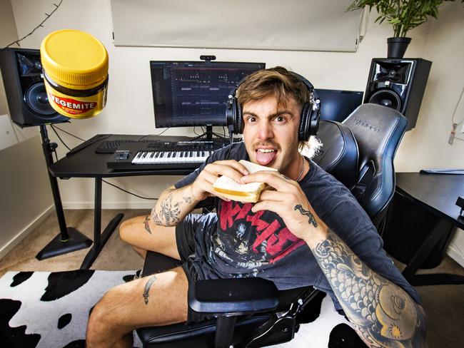 Music producer Luude – Christian Benson eating a Vegemite sandwich in his bedroom studio where he produced his latest hit track 'Down Under'. Picture: NIGEL HALLETT