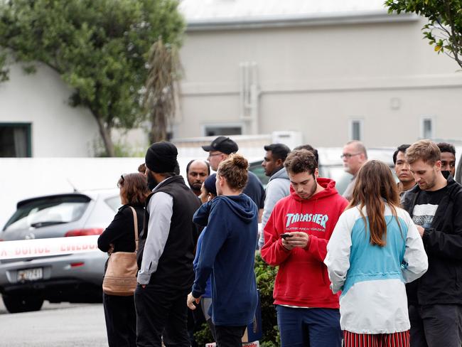 Residents gather at an area in lockdown close to the mosques. Picture: AFP