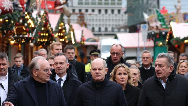 German Chancellor Olaf Scholz (C, first row), State Premier of Saxony-Anhalt Reiner Haseloff (L, first row), German Minister for Transport and Digital Affairs and of Justice Volker Wissing (L, second row), German Minister for the Environment, Nature Conservation, Nuclear Safety and Consumer Protection Steffi Lemke (R, second row) visit the site of a car-ramming attack. Picture: AFP