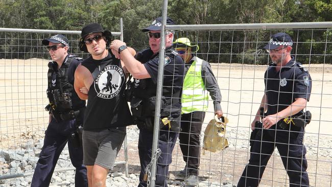 Black Swan Lake protest at Bundall goes to another level, with protesters chaining themselves to the fence and then getting themselves arrested after running onto the worksite and stopping the trucks. Protester known only as 